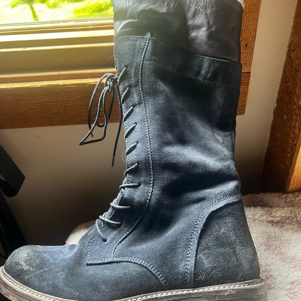 Navy blue suede boots with black leather upper and faux shearling interior.